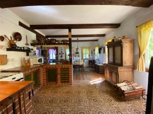 a kitchen with a stove and a living room at CHALUPA V PANSKÝM , Staré Křečany u Rumburku in Panský