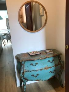a blue dresser with a mirror on a wall at Acogedor apartamento en Zumaia in Zumaia