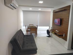 a living room with a couch and a table at apartamento duplex Arraial do Cabo VISTA PARA MAR in Arraial do Cabo