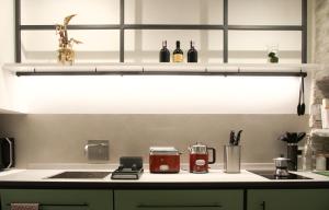a kitchen counter with a sink and bottles of wine at Loft Garibaldi, garage privato! in Perugia