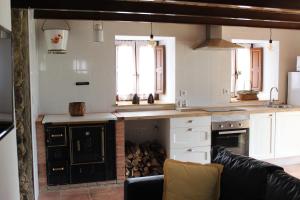 a kitchen with white cabinets and a stove top oven at Casa Pepín - Sagasta Rural Oviedo in Oviedo +33 photos
