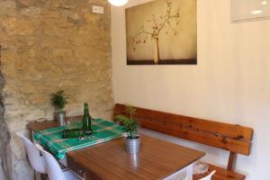 Casa Pepín - Sagasta Rural Oviedo في أوفِييذو: طاولة غرفة الطعام مع زجاجة من النبيذ عليها