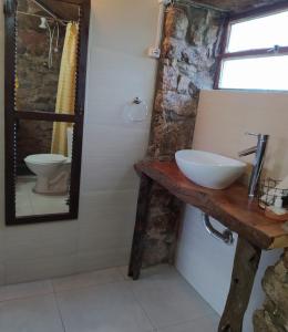 a bathroom with a sink and a mirror at El Destacamento in Villa Serrana