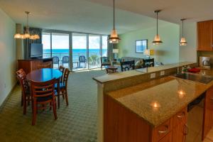 a kitchen and dining room with a view of the ocean at Deluxe Ocean Front Two-Bedroom Condo in Sandy Beach Resort in Myrtle Beach