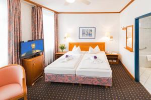 Ein Bett oder Betten in einem Zimmer der Unterkunft Hotel Alekto