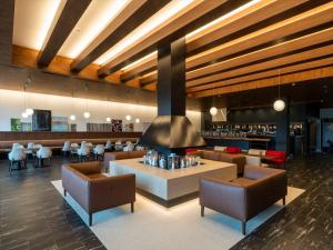 a lobby of a hotel with chairs and a bar at TORIFITO HOTEL&POD NISEKO in Kutchan