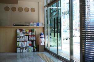 a store front with a large glass door with a head at Gloryinn in Seoul