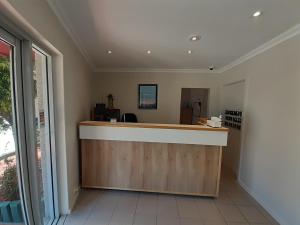 an office with a reception counter with a window at Crest Motor Inn in Queanbeyan