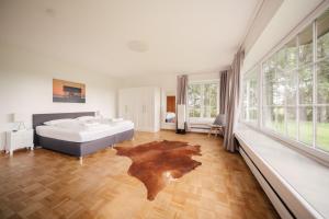 a bedroom with a bed and a wooden floor at "Reetland" - Haus Hartwig in Tating