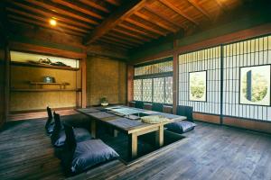 a room with a table and chairs in it at Kominkayado LOOF Okanoie in Yamanashi