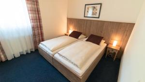 Postel nebo postele na pokoji v ubytování Hotel Lutter