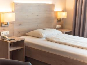 Postel nebo postele na pokoji v ubytování Hotel Lutter