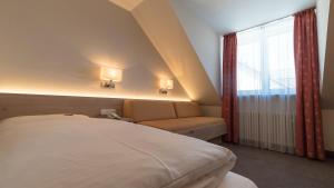 Postel nebo postele na pokoji v ubytování Hotel Lutter