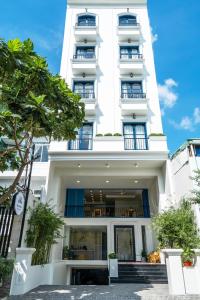 a white building with stairs in front of it at Mecozy Apartel in Ho Chi Minh City