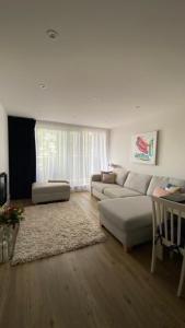 a living room with a couch and a table at Modern central flat with balcony & Free Parking on-site in Bournemouth