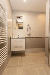 a bathroom with a sink and a mirror at Horský dom apartmány 2 in Levoča