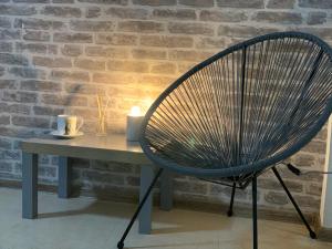 a chair sitting next to a table with a candle at Agora Studios in Plovdiv