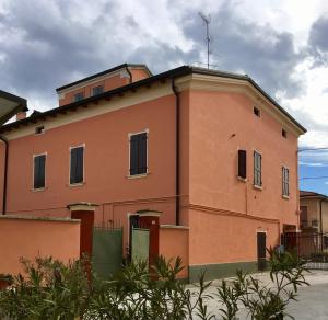 an orange building with a antenna on top of it at Portale dei Soli - Room & Breakfast in Rolo