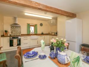 a kitchen with a table with blue and white dishes on it at The Old Cart House in Edale