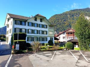 a large white building in a parking lot at Interlaken Town House Sleeps 12 guests Central in Interlaken