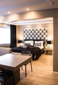 a bedroom with a bed and a couch and a table at Putiikkihotelli Pyynpesä in Sastamala +17 photos