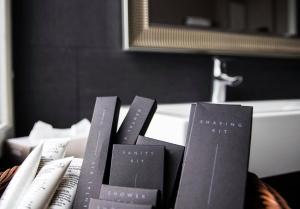 a pile of books sitting on a table in a bathroom at Putiikkihotelli Pyynpesä in Sastamala