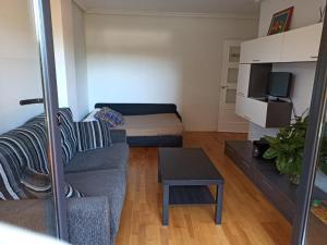A television and/or entertainment centre at Sumiciu, apartamento con piscina en Llanes VUT-1656-AS