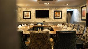 a dining room with a table and chairs at The Fenwick Hotel in Kilmarnock