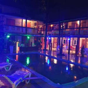 an empty swimming pool in a building at night at Hotel Ferrugem Eco Village in Garopaba