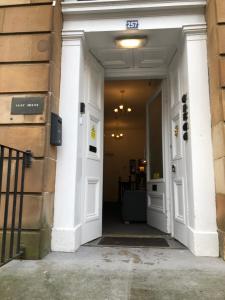 una entrada a un edificio con dos puertas blancas en Renfrew rooms at City Centre en Glasgow