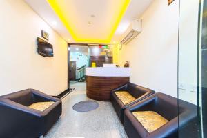 a room with two leather chairs and a bar at Mystic Globe Internatioanl Puri in Puri