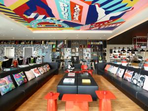 a living room filled with furniture and decorations at citizenM London Shoreditch in London
