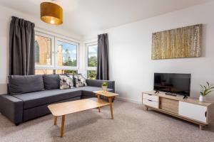 a living room with a couch and a tv at Walker Suite No53 - Donnini Apartments in Kilmarnock