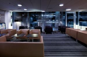 a waiting room with brown chairs and tables at Crowne Plaza Copenhagen Towers, an IHG Hotel in Copenhagen