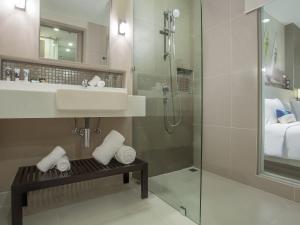 a bathroom with a sink and a shower at Mercure Pattaya Ocean Resort - SHA Extra Plus in Pattaya