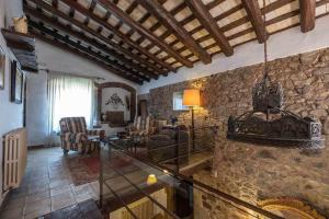 a large living room with a stone wall at Mas Grau Casa con Encanto en Girona in Estanyol