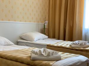 Postel nebo postele na pokoji v ubytování Sergeev Hotel