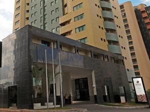 a building in front of some tall buildings at Apart Hotel - Esplanada dos Ministérios - Centro de Brasília in Brasilia