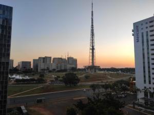 a view of a city with a tower in the distance at Apart Hotel - Esplanada dos Ministérios - Centro de Brasília in Brasilia