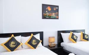 Postel nebo postele na pokoji v ubytování Hoang Long Hotel Phan Thiết