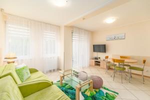 a living room with a couch and a table at Apartment Bielik A01 by Renters in Międzyzdroje