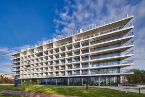 un grand immeuble de bureaux avec beaucoup de fenêtres dans l'établissement Seaside Park Apartament Prywatny 405 z widokiem na morze, à Kołobrzeg