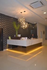 a lobby with a reception desk in a building at Ashley Boutique Hotel in Kota Damansara