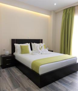 a bedroom with a bed with a towel on it at Tresor Apartments in Parga
