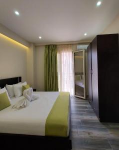 ein Schlafzimmer mit einem großen Bett und einem großen Fenster in der Unterkunft Tresor Apartments in Parga