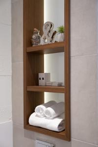 a wooden shelf with towels on it in a bathroom at SL Panorama in Trebinje