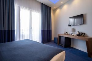 a hotel room with a bed and a television at SL Panorama in Trebinje
