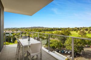 a balcony with a table and chairs and a view at Quest Toowoomba in Toowoomba