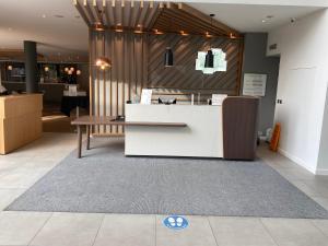a lobby with a reception desk in a store at Holiday Inn Sittingbourne, an IHG Hotel in Sittingbourne