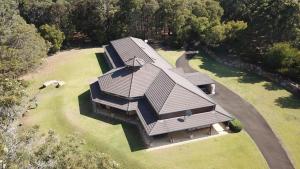 an overhead view of a house with a roof at Harmony Forest Cottages & Lake side Lodge in Margaret River Town